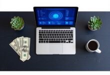 Laptop showing AI dashboard on desk with dollar bills — entry level AI jobs for students