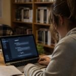 UK university student using AI tools on laptop for freelance side hustle income